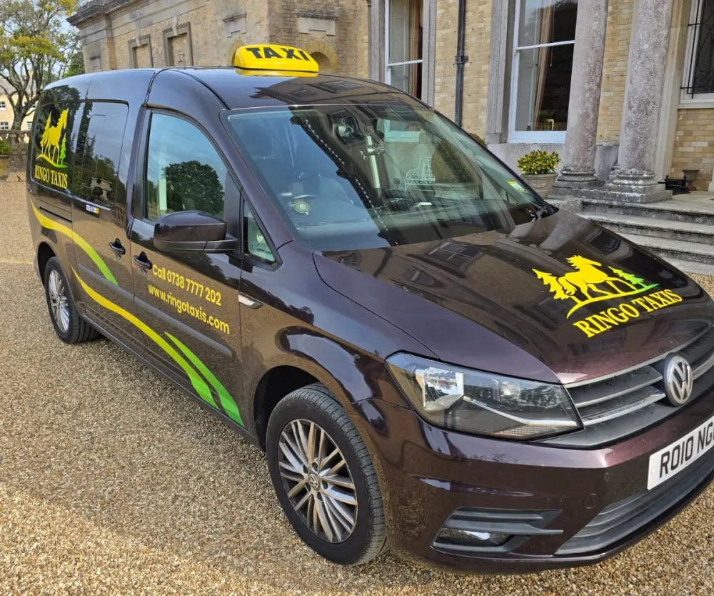Front of the Ringo's Taxis branded taxi with roof sign